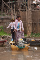 Boy on boat unloading / Experiences when travelling through villages in Cambodia