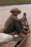Steering the boat / Experiences when travelling through villages in Cambodia